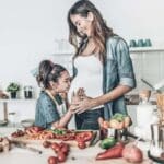 mother and daughter cooking in the kitchen